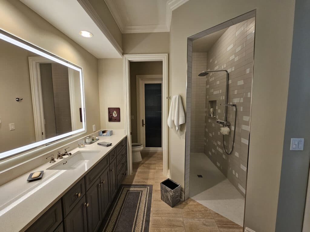 Luxury doorless shower entry with a sink on the left in Fort Myers