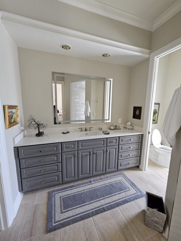 Custom made bathroom vanity, with a grey wood front and white marble on the top in Estero Florida
