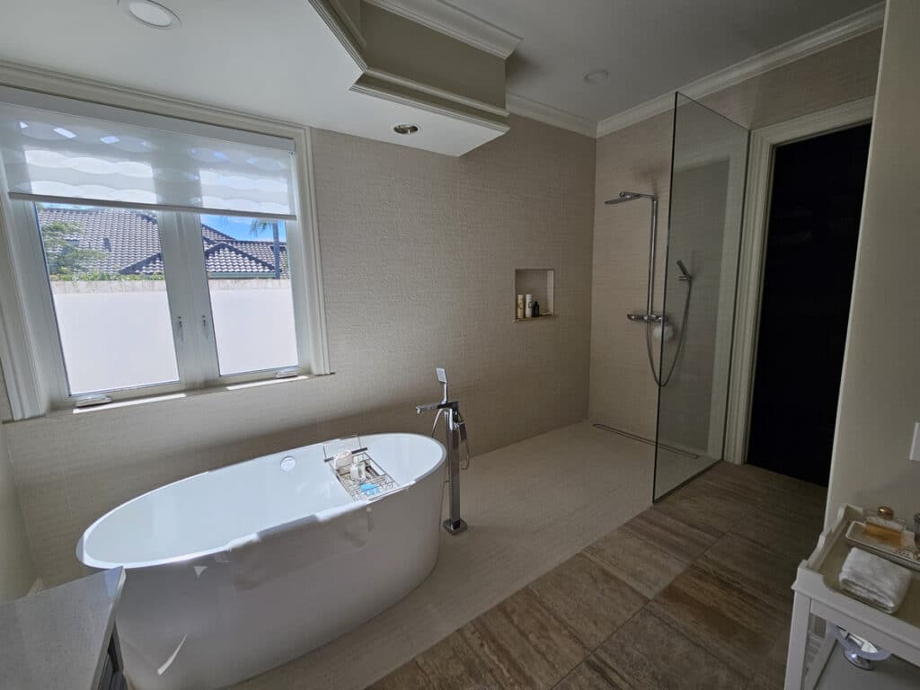 Guest bathroom upgrade with a seamless walk-in shower and stand alone tub on Sanibel Island