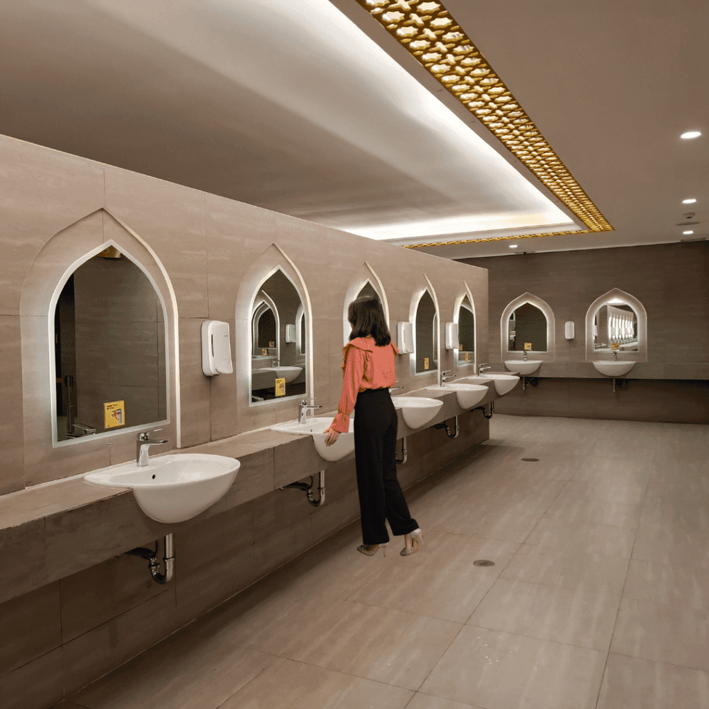Women standing in front of a room in a tuscan style public restroom in naples