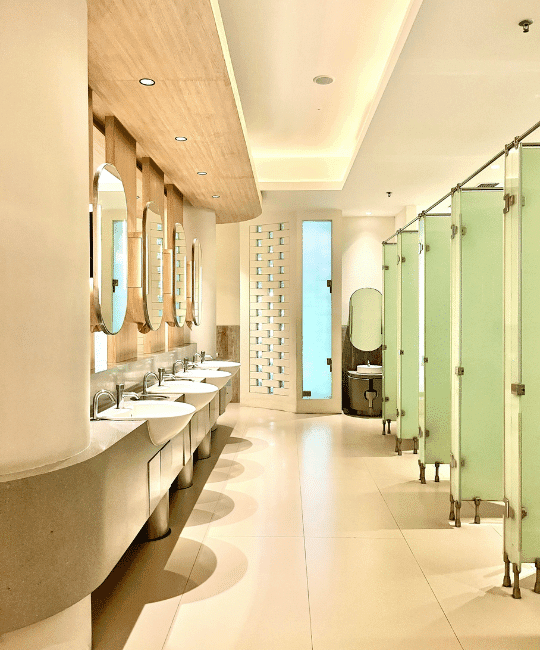Custom Comercial Restroom with lime green doors on the right (stalls) and sinks on the left