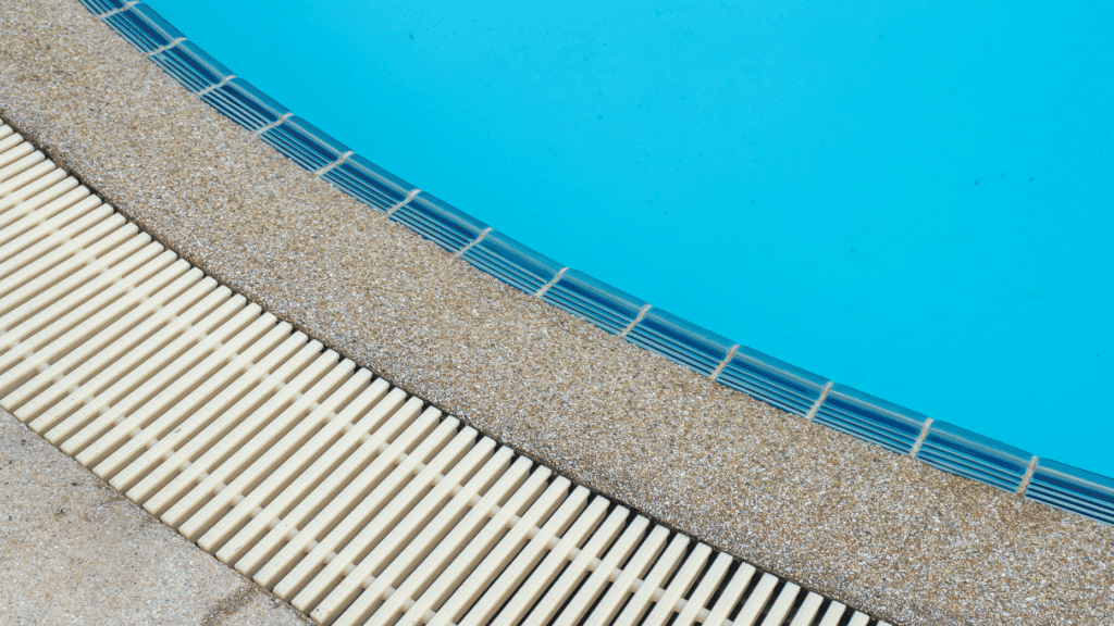 Slip Resistant Pool Gripped step near a commercial pool's edge, with a water dran